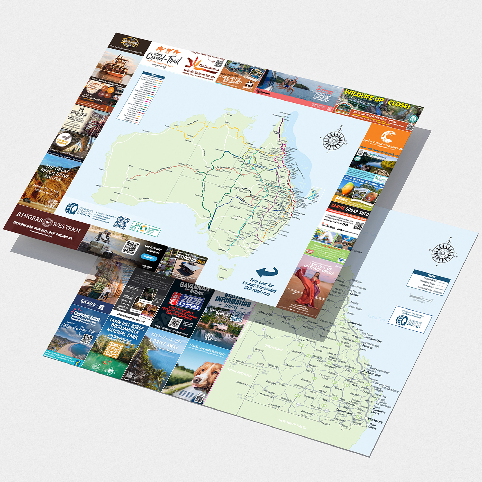 Two printed brochures are shown, featuring detailed maps of Australia and Queensland surrounded by various advertisements and informational panels.